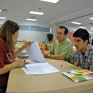 A student and parent receiving help from Financial Aid.
