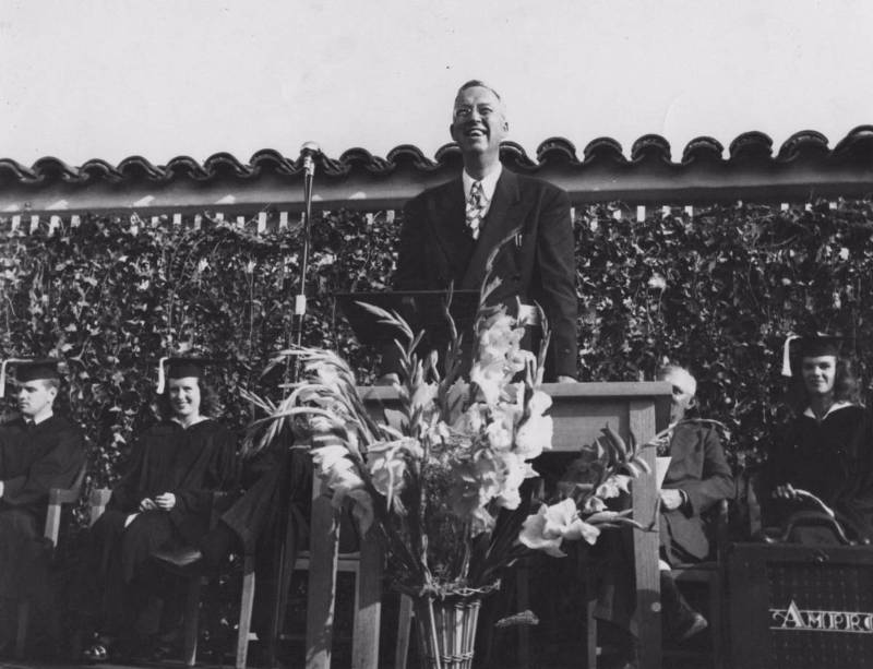 Mt. SAC's first president, Dr. George Bell, at the college's first graduation in 1947, reads a telegram from California Governor Earl Warren: "Thought you and your graduates might be interested to know I am today signing Assembly Bill 1904 making it possible for you to acquire the present site as a permanent home for Mount San Antonio College."
