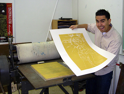 Student printing silk screened artwork
